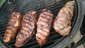 New York Strips Being Spritzed with 